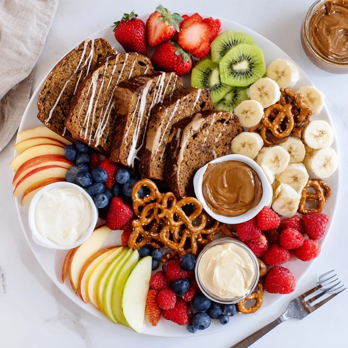 Indulgent caramel banana bread charcuterie board with fresh fruits and creamy spreads.