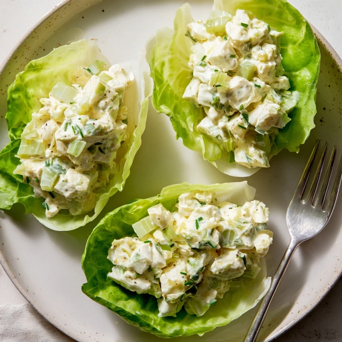Chilled egg salad lettuce wraps nestled in crisp leaves for a light meal.
