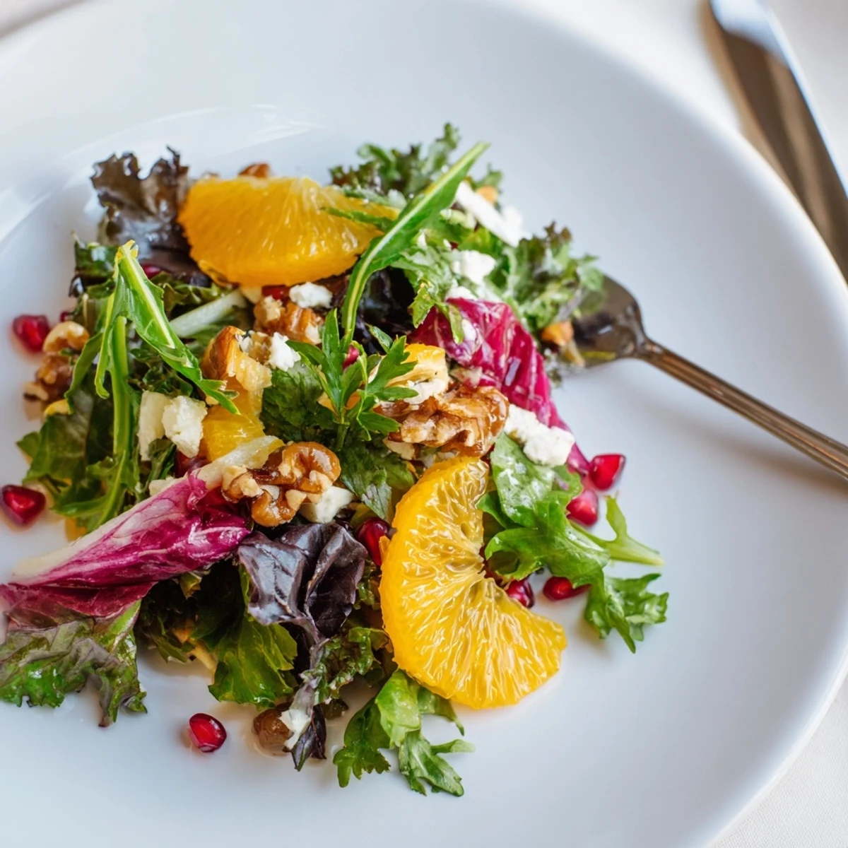 Winter Greens Salad bursting with colorful citrus and ruby pomegranate, topped with toasted nuts.
