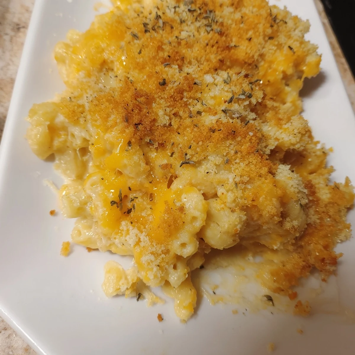 Enjoy a comforting plate of cheesy, delicious Baked Macaroni and Cheese, perfect for dinner tonight.