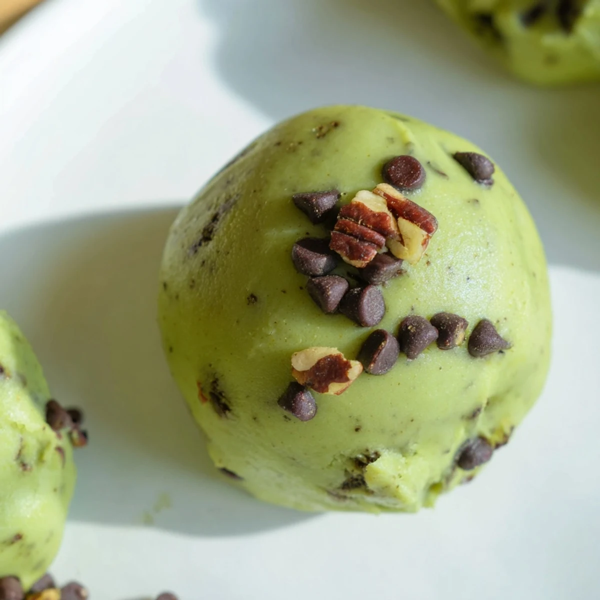 Matcha Gingerbread Cookie Dough Protein Bites, rolled into perfect spheres, ready for a healthy snack or breakfast.