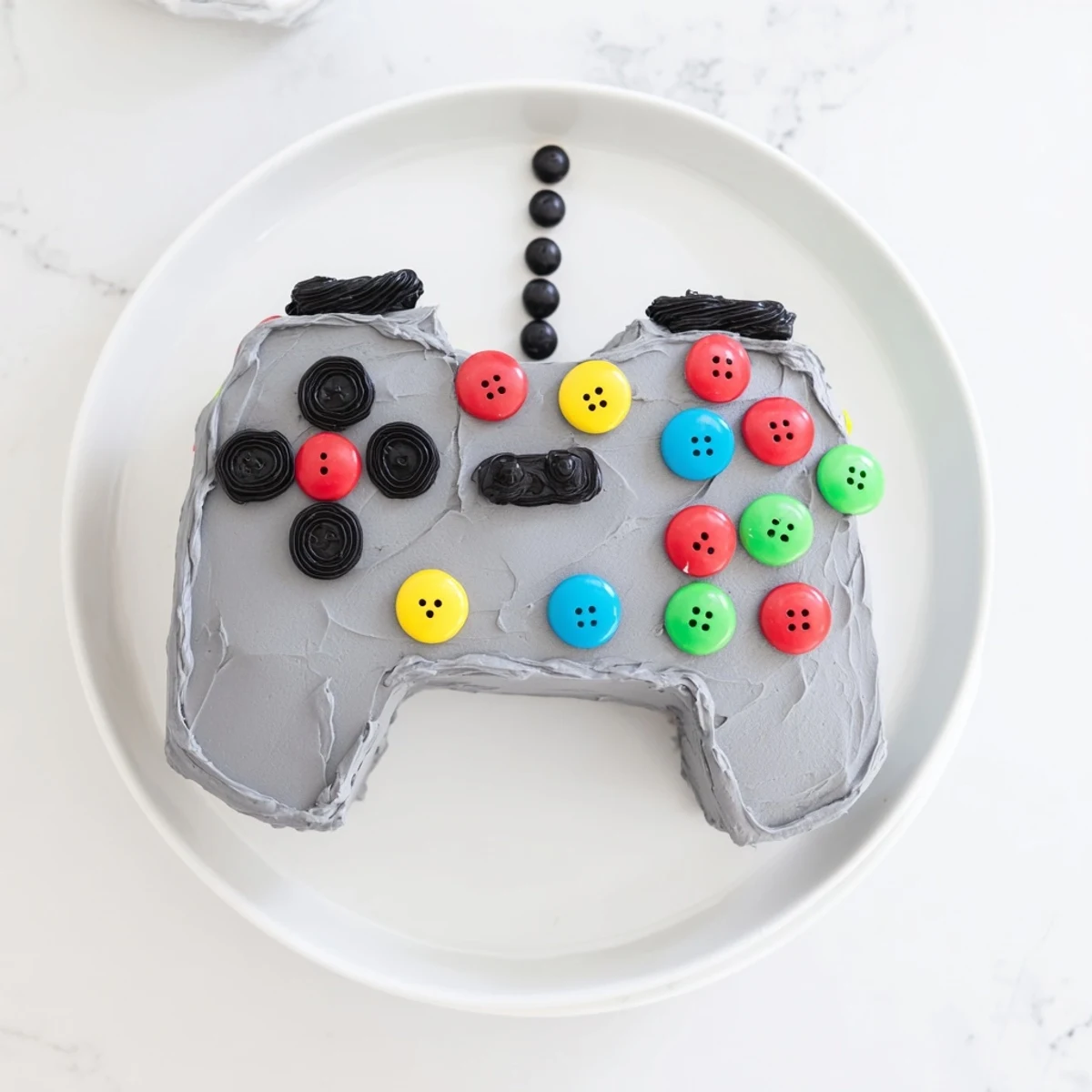 Vibrant pixel-perfect video game controller cake, a delicious dessert perfect for any gamer's birthday party.