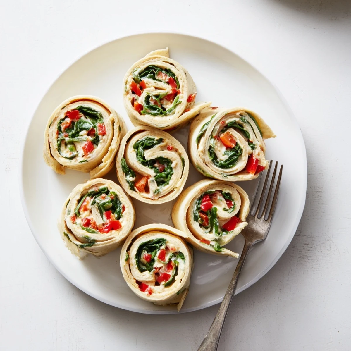 Perfectly sliced Christmas Scarf Tortilla Roll-Ups: beautiful spirals offer a delightful vegetarian appetizer option.