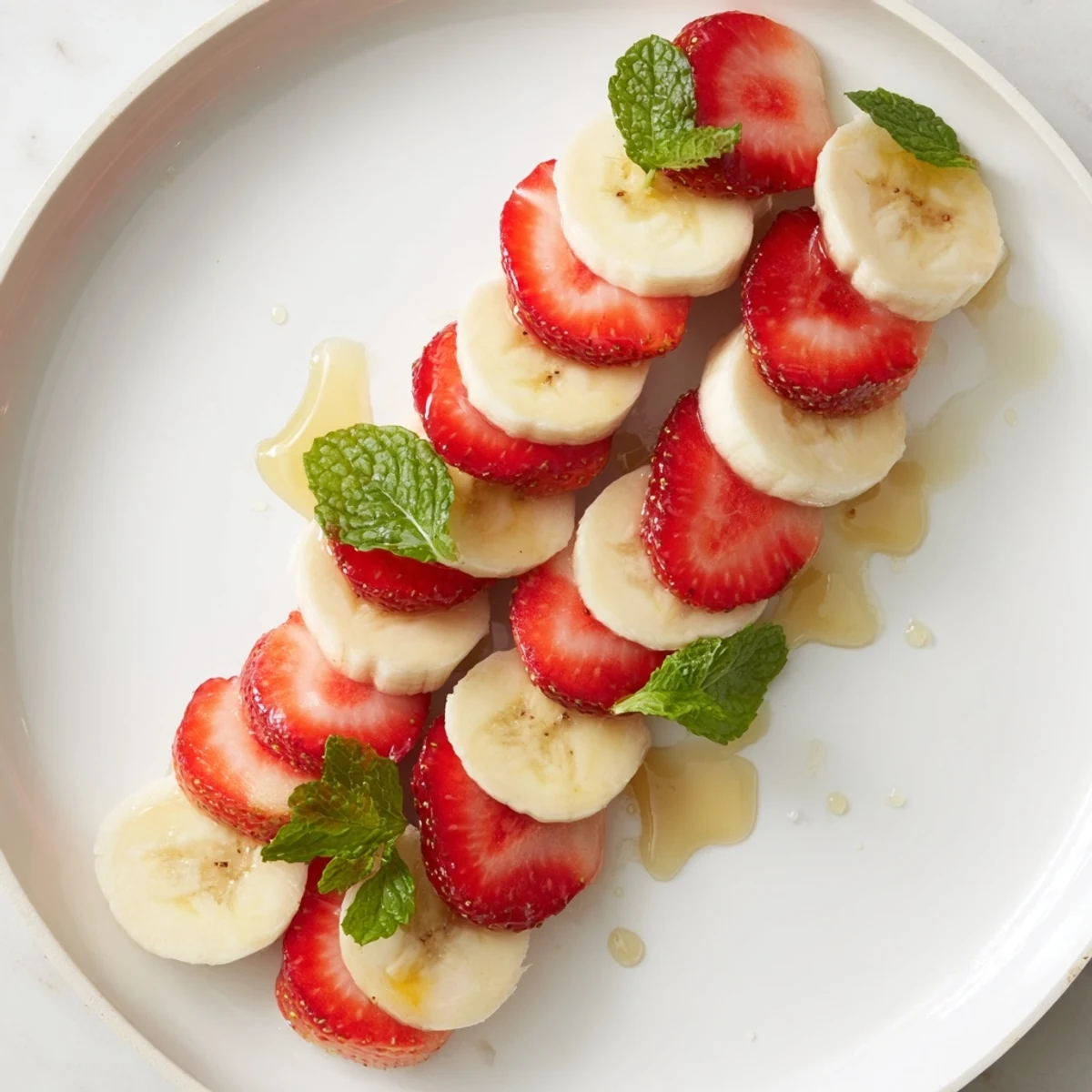 Vibrant Banana Strawberry Candy Cane: a colorful, healthy snack artfully shaped on a plate.