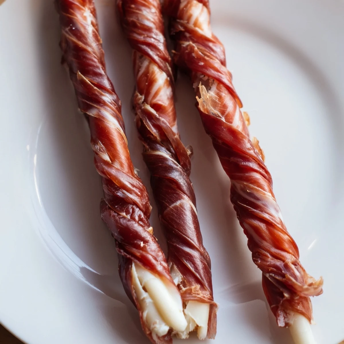Savory, woven Nautical Knot appetizer, a braided prosciutto-wrapped cheese rope, ready to be enjoyed.