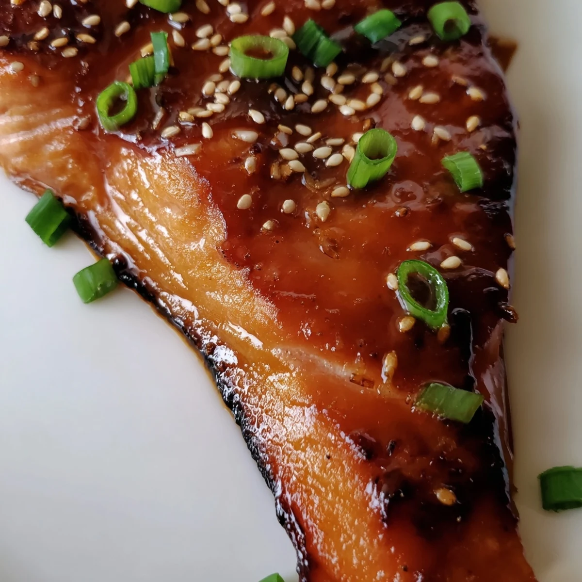 A close-up shot of perfectly cooked ginger soy glazed salmon, ready for your next dinner.