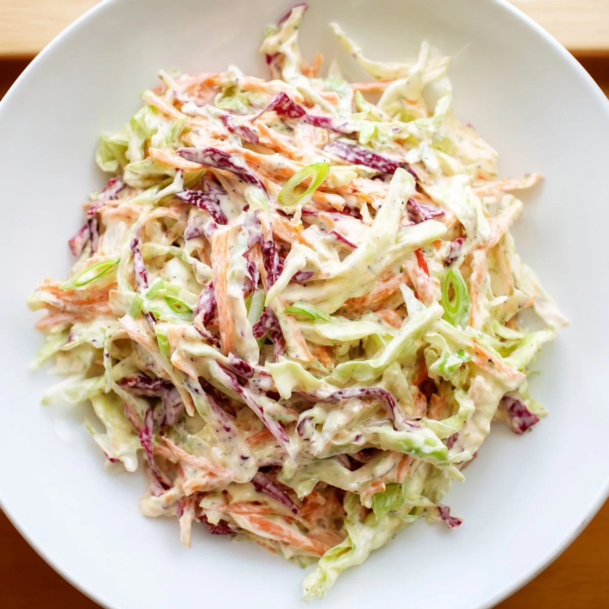 A close-up shot of Quick Coleslaw Salad, a cool and refreshing side dish ready to eat.