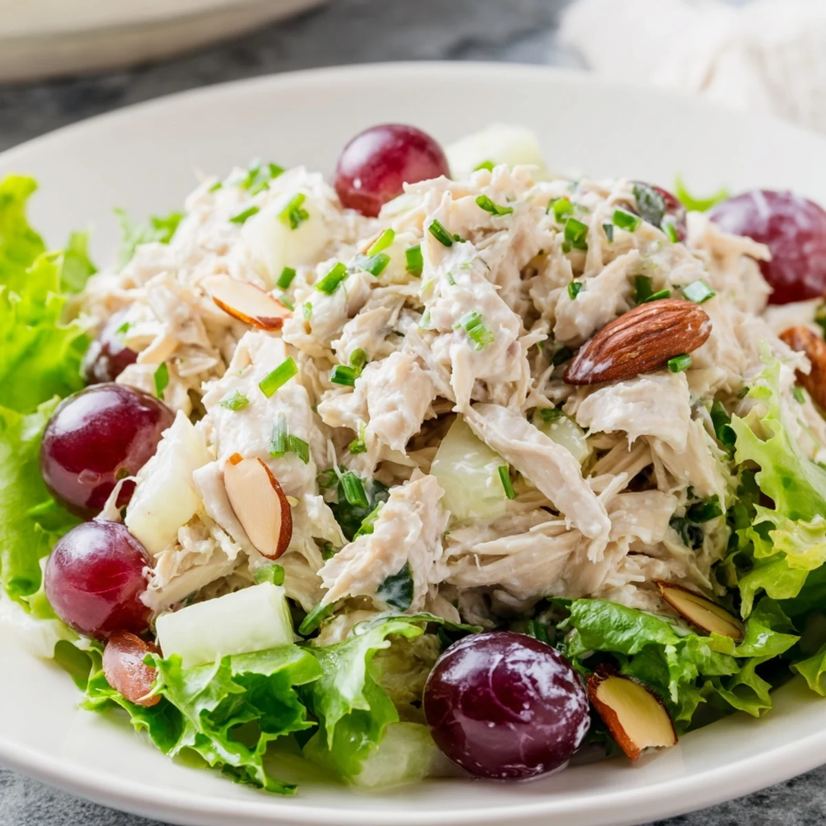 Creamy Crispy Chicken Salad with juicy grapes, ready to serve on a bed of fresh, vibrant salad greens.