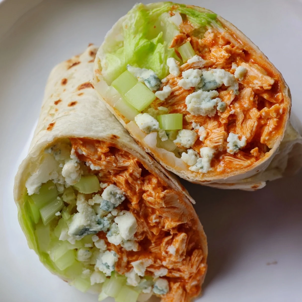 Golden-brown Buffalo Chicken Dip Wrap, with melty cheese and tender chicken visible in a cross-section.