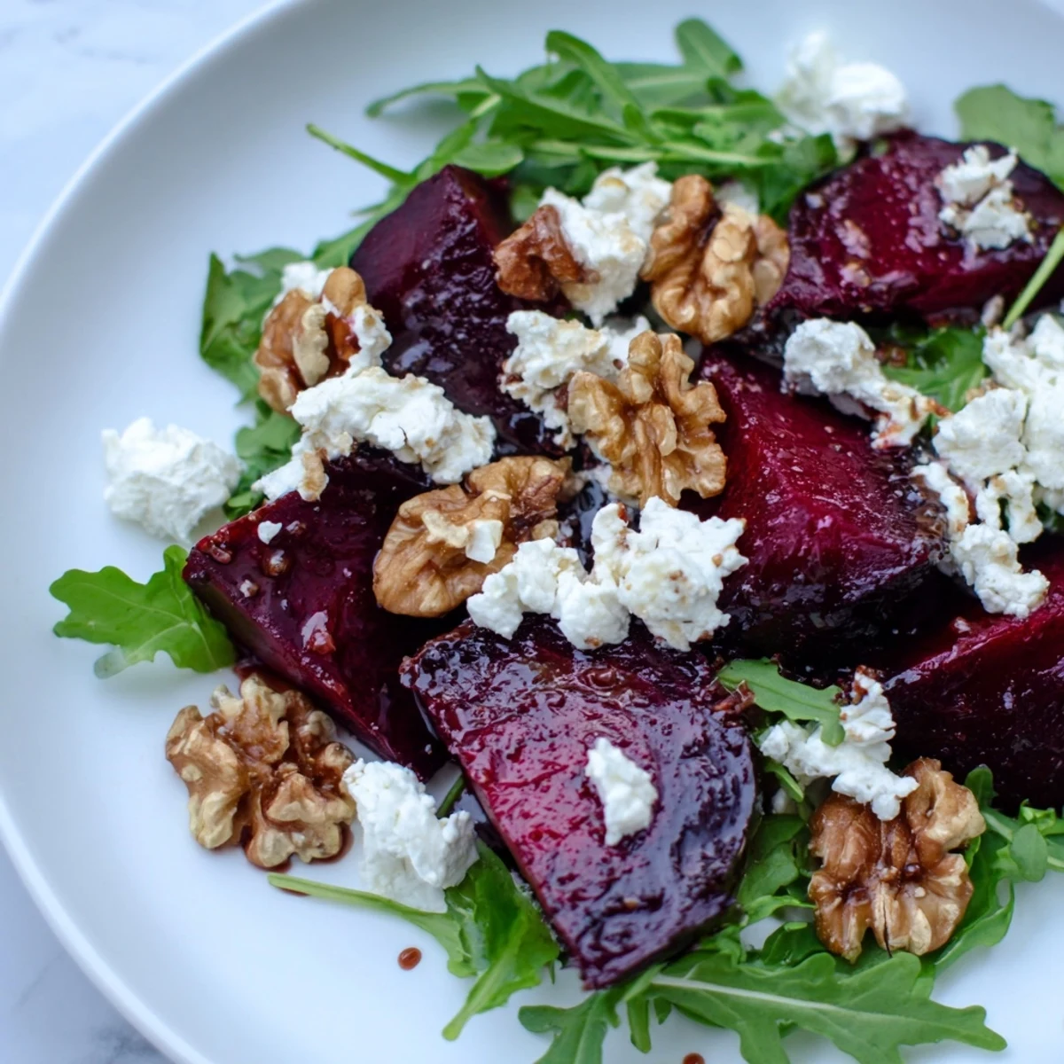 Plate of Roasted Beet Walnut Salad, featuring vibrant beets and crumbled goat cheese.