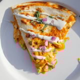 A close-up of a delicious Buffalo Chicken Quesadilla, featuring crispy edges and savory chicken inside.