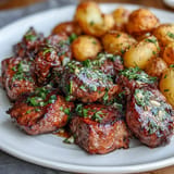 Tender steak bites and crispy potatoes in a savory garlic butter sauce.
