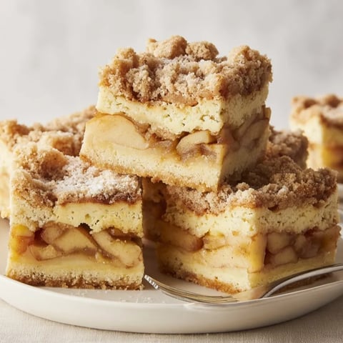 Golden Ricotta Cinnamon Apple Pie Bars, a warm swirl of fall flavors.