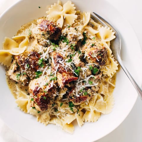 Delicious Mozzarella Garlic Butter Chicken Bowties garnished with fresh parsley and melted cheese.  