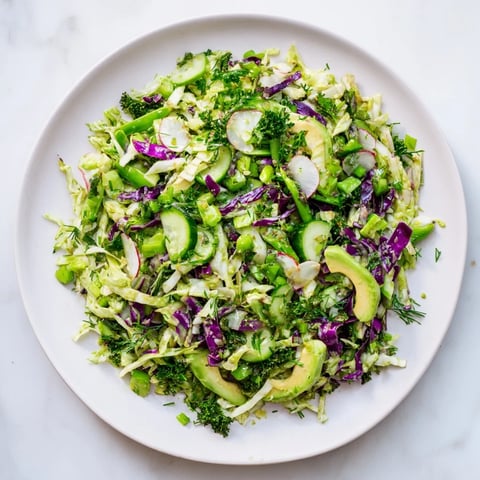Green Goddess Detox Cabbage Salad with colorful raw vegetables, drizzled with bright, zesty dressing.