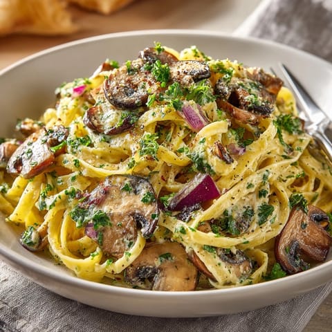 Freshly made Forest Floor Pasta with mushrooms, herbs, and garlic; ready to serve with parmesan.