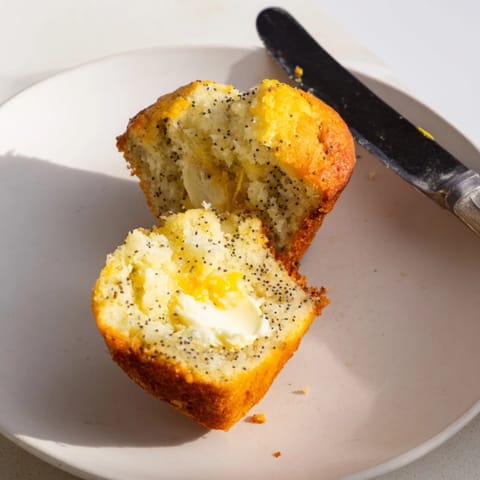 Warm, homemade ricotta lemon poppyseed muffins cooling on a wire rack, zesty aroma.