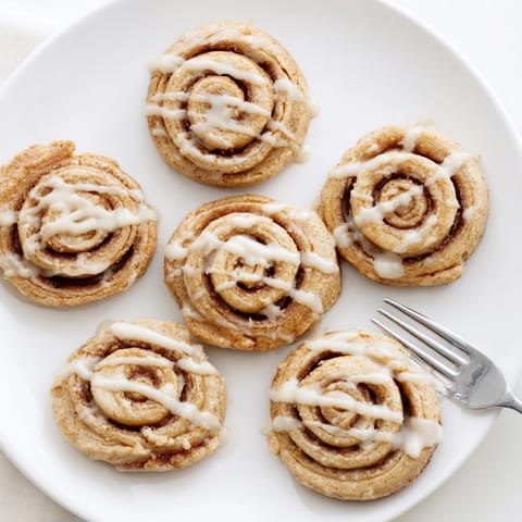 Close-up of a Peanut Butter Cinnamon Roll Cookie revealing moist, swirled sugary layers inside.