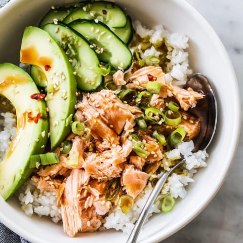 Microwave-steamed leftover salmon and rice bowl topped with vibrant, fresh ingredients.  