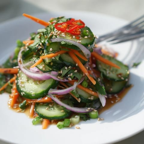 Vibrant cucumber salad remix with Asian flavors, ideal as a light appetizer.  