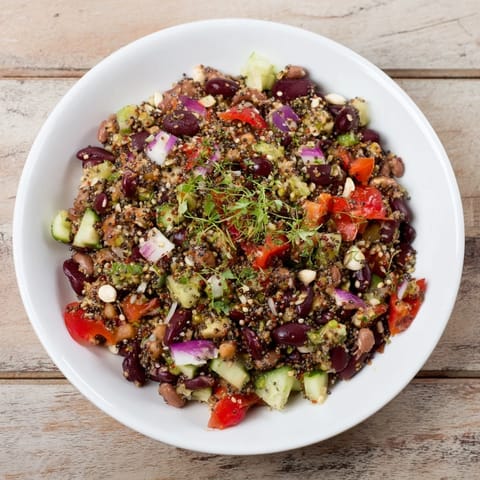 A colorful bowl of chilled Dense Bean Salad, tossed with a tangy lemon dressing for lunch.