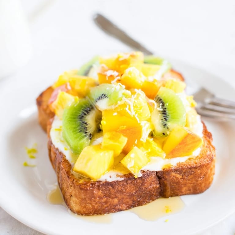 Colorful yogurt-custard toast bursting with mango, pineapple, and kiwi flavors.  