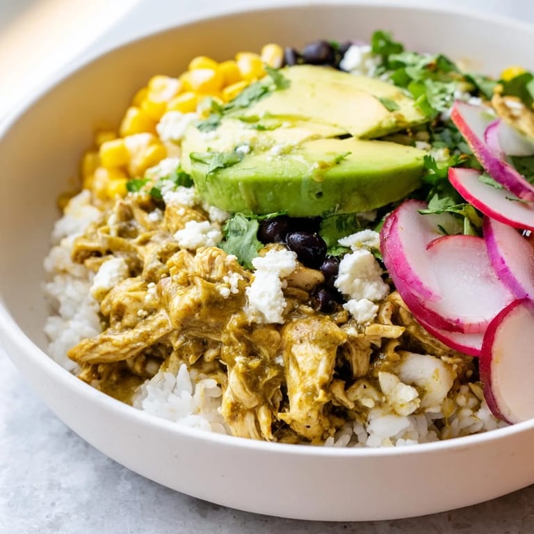 Enjoy a delicious homemade Green Enchiladas Rice Bowl, with all the fixings, ready in under an hour.