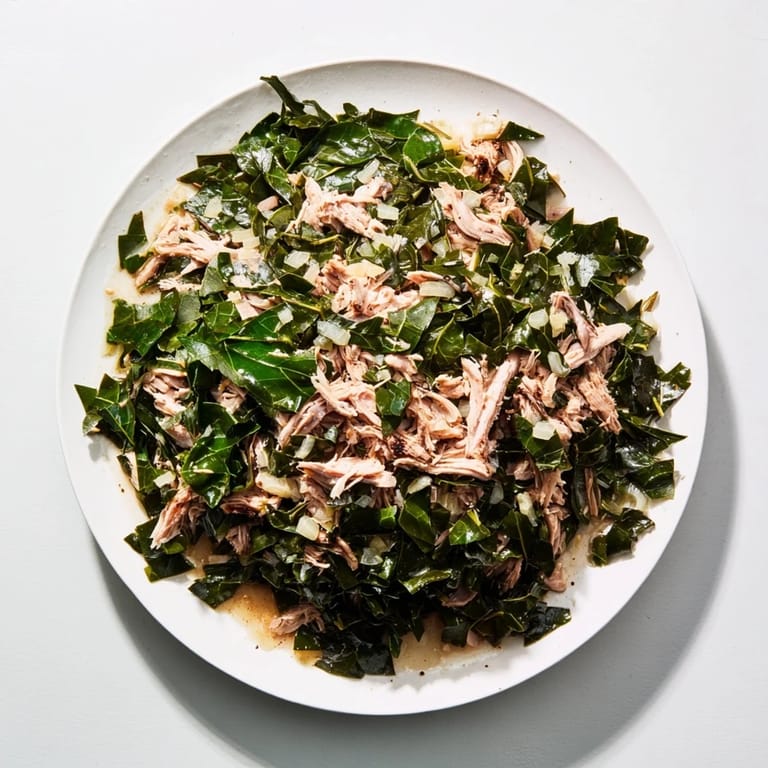 A steaming bowl of Southern style collard greens with turkey, a flavorful and hearty dish, ready to eat.