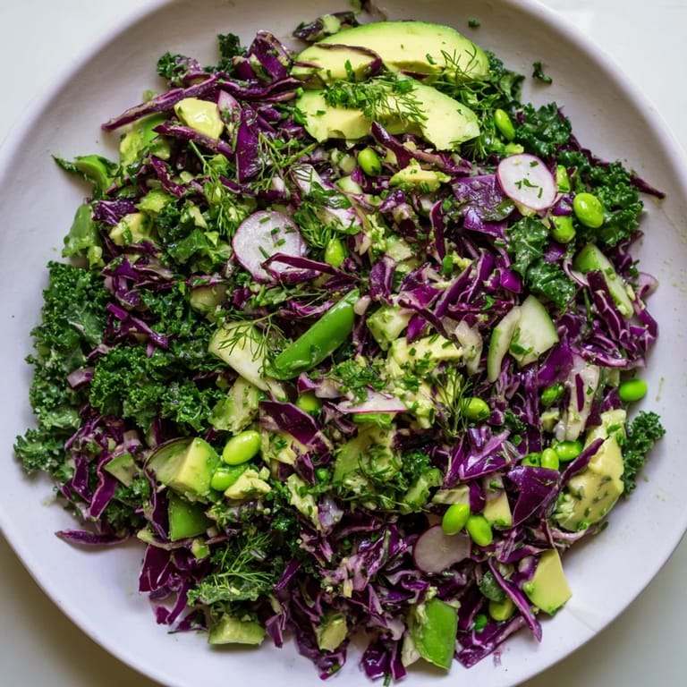 Freshly tossed Green Goddess Detox Cabbage Salad, a vibrant vegan dish bursting with flavorful herbs and vegetables.