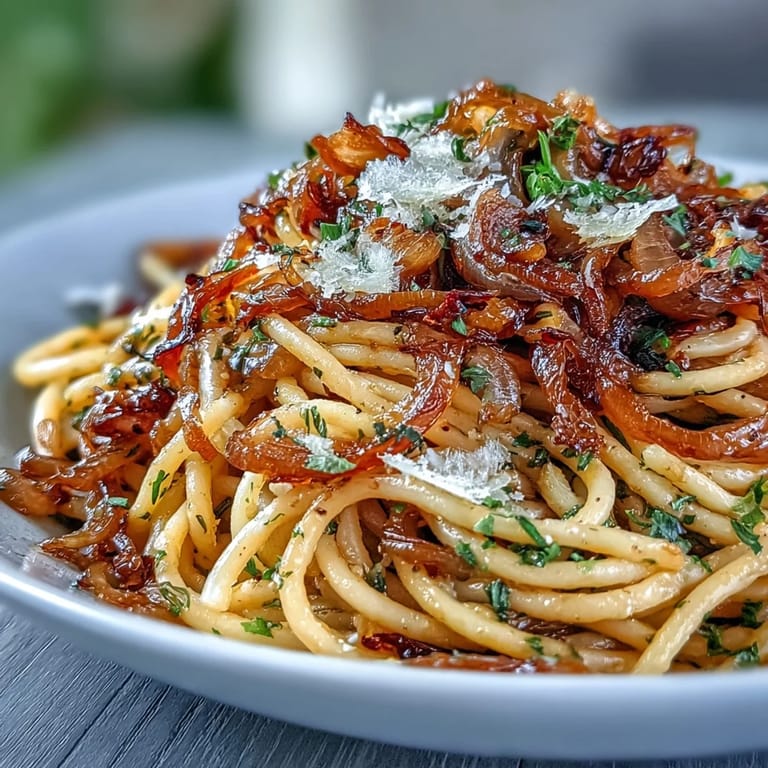 Savory, sweet, and spicy pasta dish served hot in a white bowl, garnished with chopped fresh basil for color.