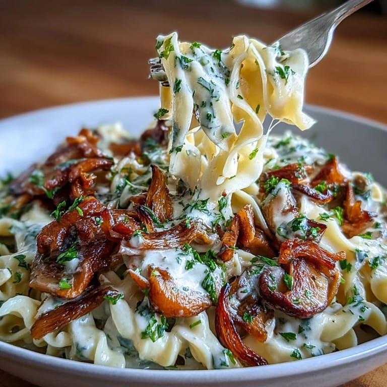 Vegetarian stroganoff with sautéed onions, mushrooms, and a smooth sour cream sauce atop wide egg noodles.  
