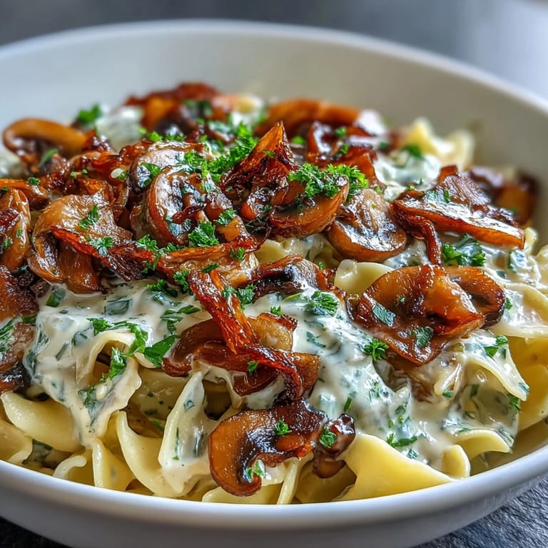 Hearty mushroom and onion stroganoff in a paprika-spiced sauce, served over freshly cooked egg noodles.